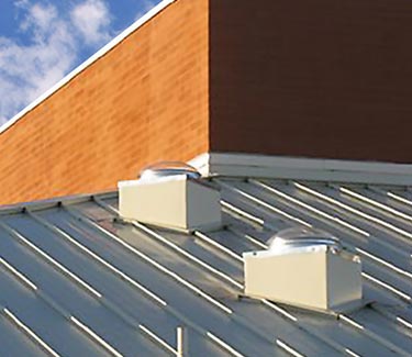 Two Natural Light tubular skylights installed on metal roof curb mount thumb